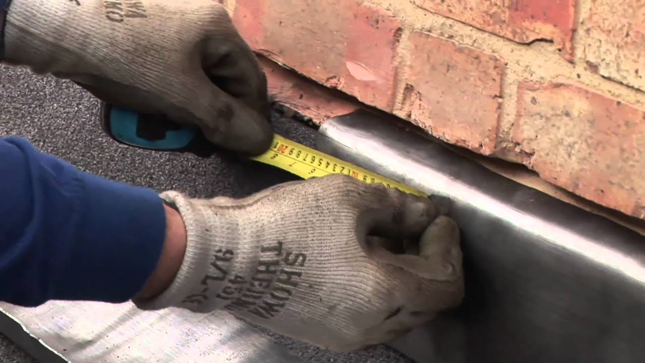 Step flashing and apron dressed to brickwork